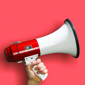 A megaphone held by a human hand